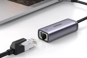 Zo kijk je IPTV op je pc, stap voor stap 4 USB-C-naar-ethernetadapter naast een laptop en een RJ45-netwerkkabel.